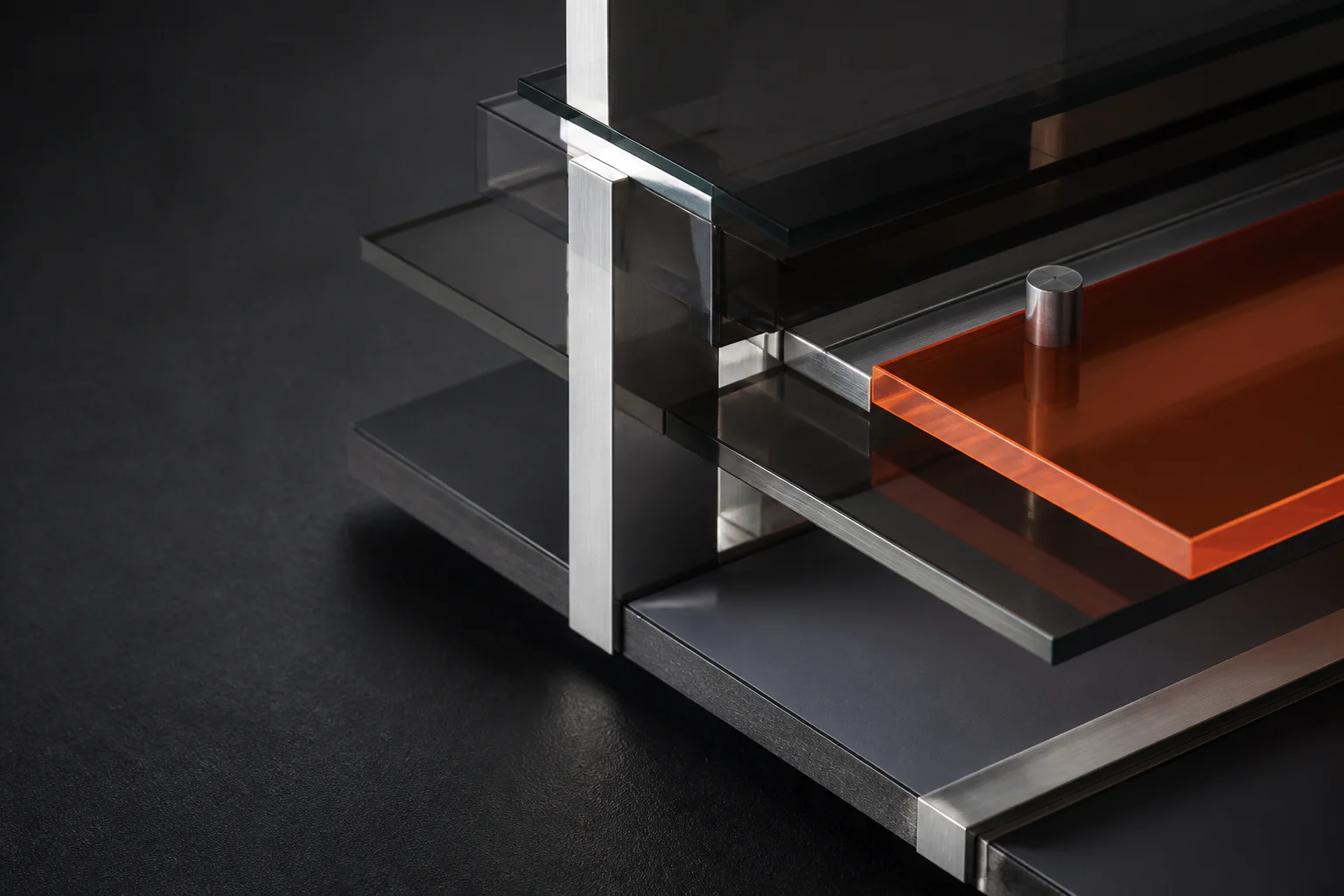 Layered black glass, brushed aluminum and translucent orange acrylic